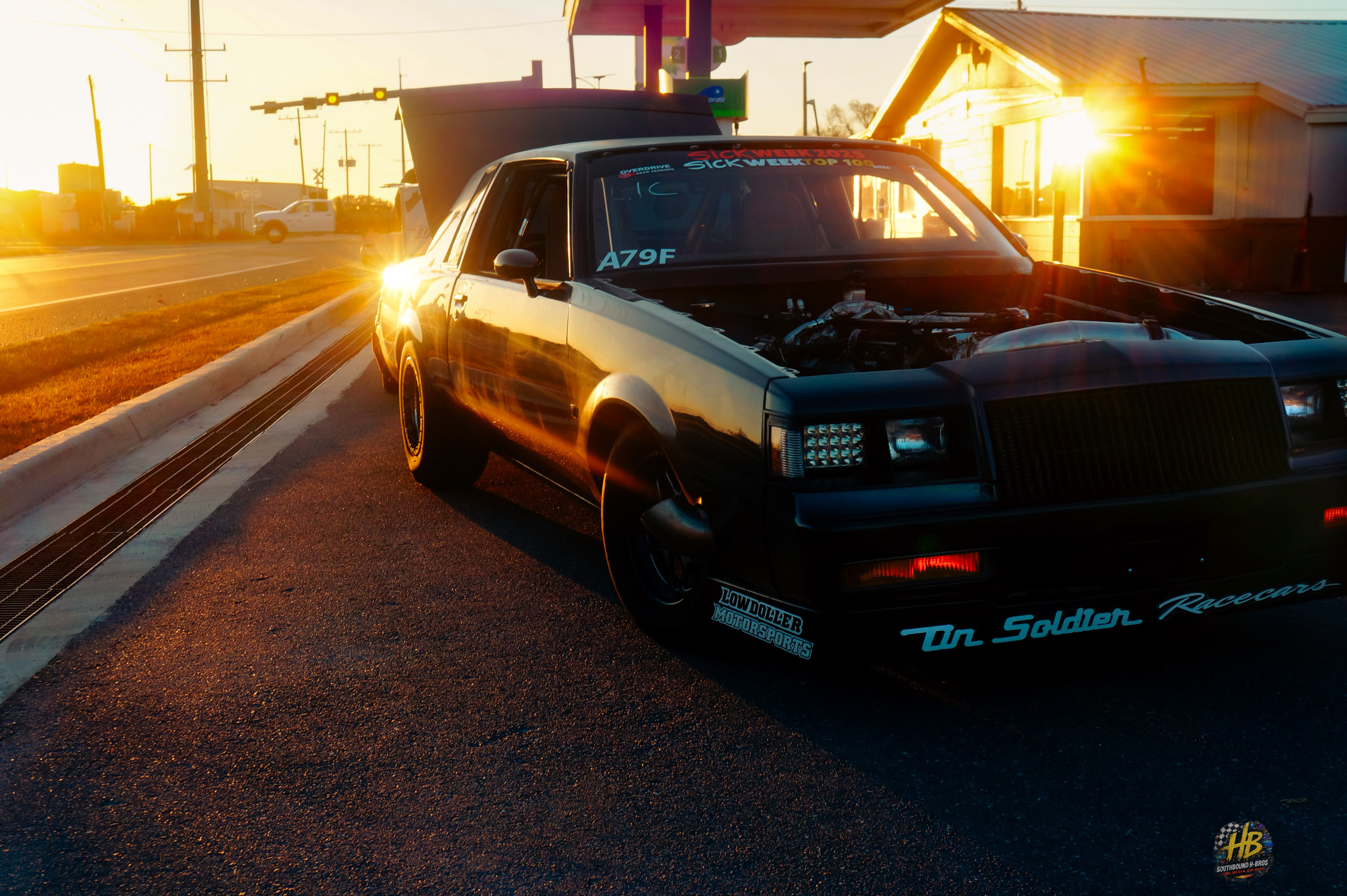 Black performance car at sunset